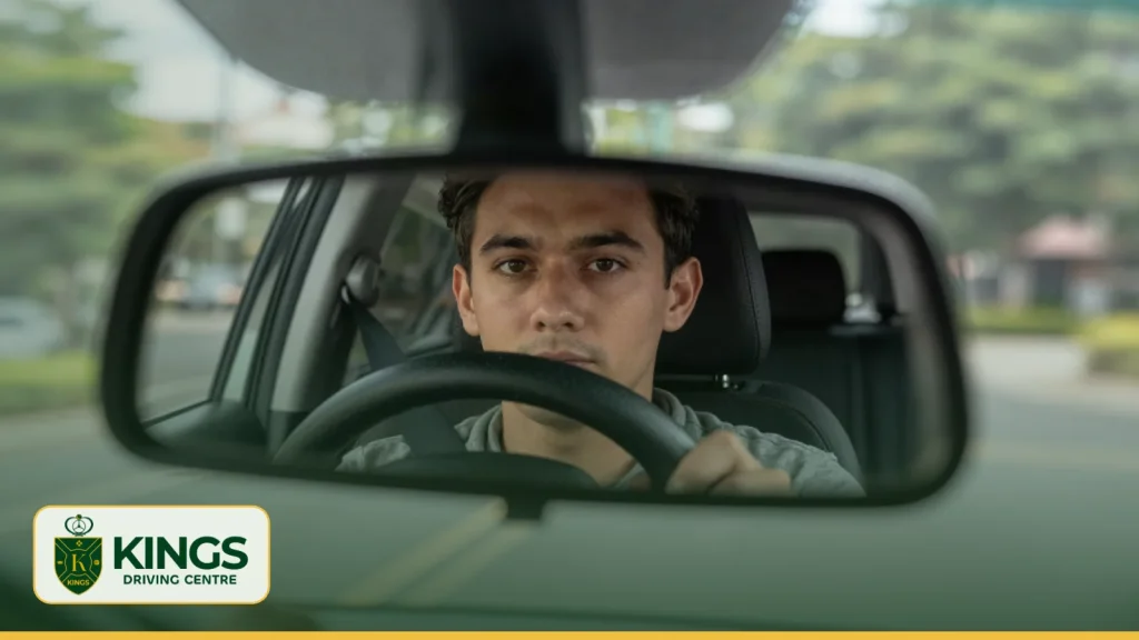 Learner driver checking the rear-view mirror
