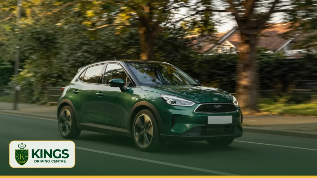 Green car driving along a tree-lined suburban street