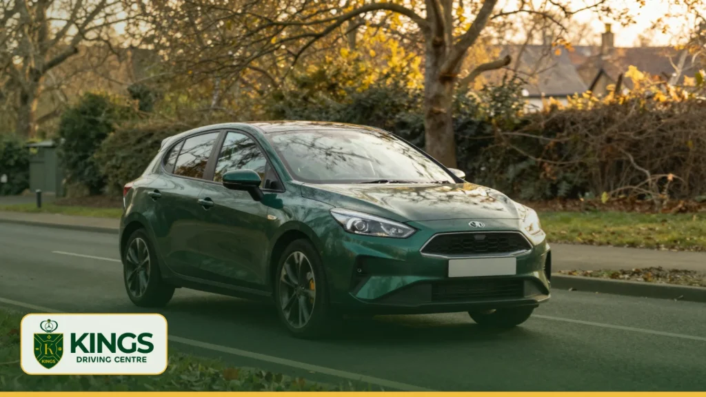 Green car driving on a leafy suburban road near Tolworth